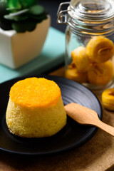Gold egg yolk thread chiffon cake (Thai cake) on black plate
