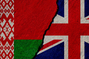 belarus and united kingdom flags painted on cracked concrete wall