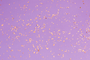 Falling gold confetti on purple background. Backdrop for parties, celebration an Birthdays.