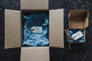 product tags with small business vs big brand texts inside of bigger and smaller delivery parcels,...