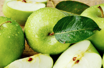 Health Benefits Of Green Apples.
Green apples with leaf  on wooden background.