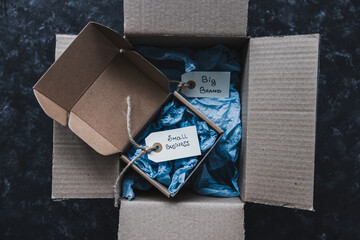 product tags with small business vs big brand texts inside of bigger and smaller delivery parcels,...