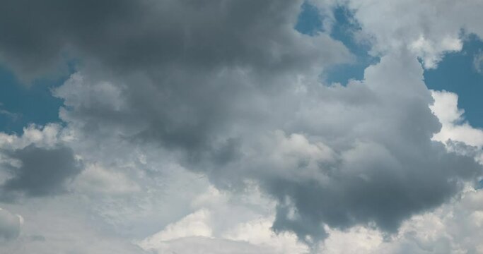 4K Motion dark sky timelapse summer tropical storm sky and fluffy white darkness cloud nearly raining cloudscape. nimbus raincloud skyline climate background. Dark gray sky cloudy environment