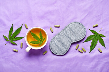 Healthy night sleep concept. Sleep mask, calming hemp tea and hemp capsules on silk lilac background