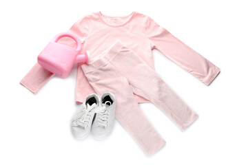 Children's clothes and toy on white background