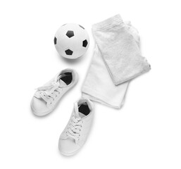 Children's clothes and ball on white background