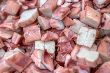 Pieces of sea cuttlefish squid cut into cubes. Ready-made ingredients for sea salad