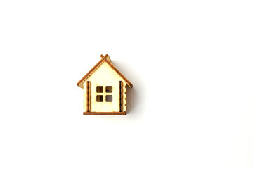 Miniature wooden toy house isolated on a white background. Real estate object. Concept of buying an apartment, house, real estate. Copy space.