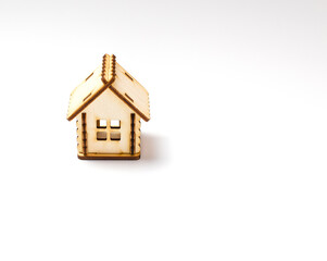Miniature wooden toy house isolated on a white background. Real estate object. Concept of buying an apartment, house, real estate. Copy space.