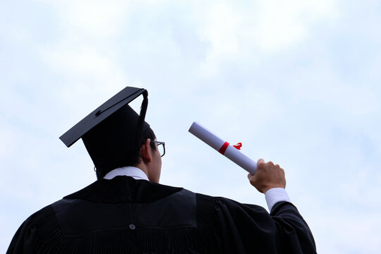 Student with congratulations, graduates wearing a graduation gown of university.