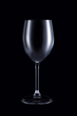 Empty wine glass isolated on dark background. Studio