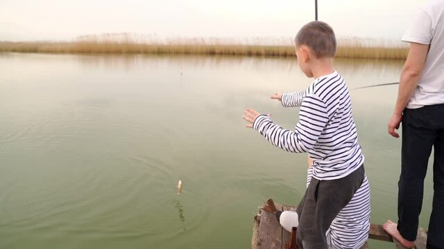 A boy grab a fish caught on a fishing trip
