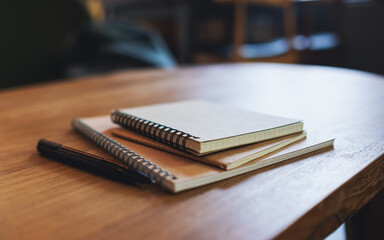Closeup image of notebooks on wooden table