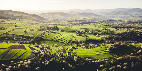 Spring landscape in Slovakia. Polana region, Hrinova. Green spring rural hills landscape, fields, flowering trees, organic farming © Zedspider