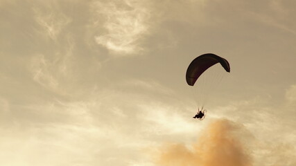 paragliding silhouette with sunset background