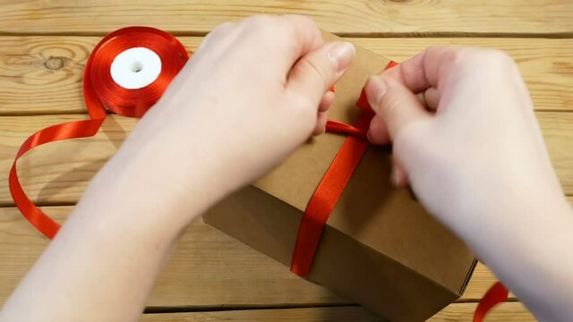 Gift parcel box with ribbon red bow, brown carton parcel, surprise
