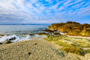 Landscape with beach,the sea and the beautiful clouds in the blue sky.rocks on the beach.