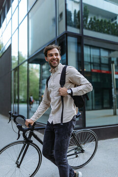 Young Stylish Businessman Going To Work By Bike In The City