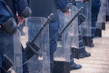 Riot police practice shields and baton