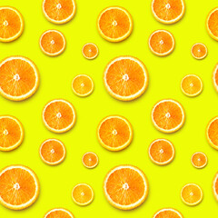 Ripe orange slices on a bright background. Seamless background.