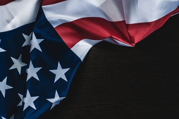 American flag on dark wooden background with place for text