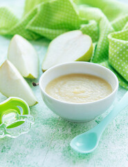 Bowl with fruit baby food and pears