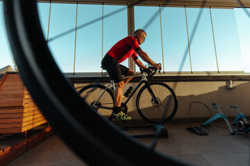 Elderly man exercising on bike indoors