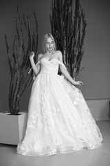 The beautiful young woman posing in a wedding dress