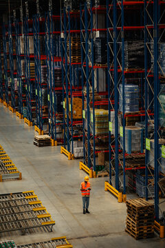 Warehouse worker checking stock inventory via technology