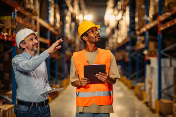 Warehouse staff meeting, worker with manger