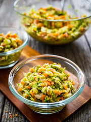 Fresh spring vegetable salad on wooden table