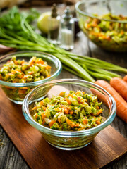 Fresh spring vegetable salad on wooden table