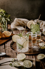 Dark photography with a vintage look of a cold drink, a glass of mojito with mint leaf, ice, lemon...