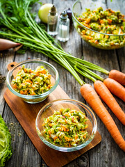 Fresh spring vegetable salad on wooden table