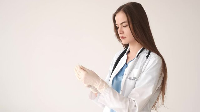 A young female doctor holding a medical syringe