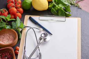 Fresh fruits and vegetables for background, Different fruits and vegetables for eating healthy, Colorful fruits and vegetables. top view of blank clipboard with pen near stethoscope.