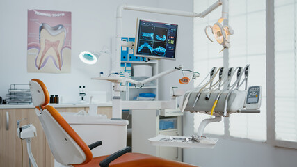 Interior of empty stomatology orthodontist office with nobody in it prepared for tooth surgery. Zoom in shot of teeth radiography on monitor. Orthodontic clinic with professional dentist equipment