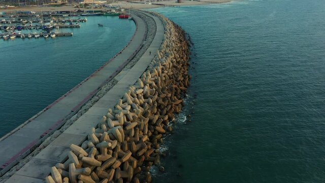 Aerial Shot Of Groyne By Harbor At Sea, Drone Descending Over Concrete Tetrapods - Ashdod, Israel