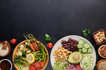 Vegan protein source. Buddha bowl dish, avocado, pepper, tomato, cucumber, red cabbage, chickpea, fresh lettuce salad and walnuts, nuts, beans, . Healthy vegetarian eating, super food. Top view.
