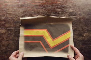 On the scratched table lies an old, tattered piece of paper with