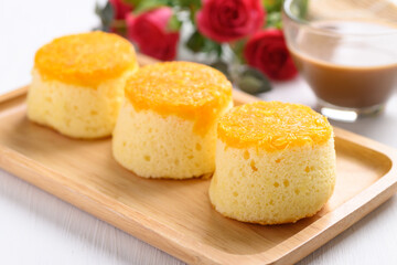 Thai gold egg yolk thread chiffon cake on wooden plate and coffee