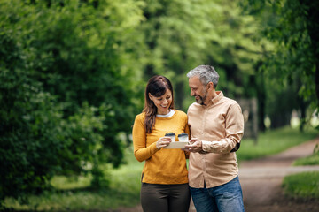 Adult woman accepting coffee from her husband.