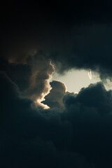 Airplane with smoke trails in the storm clouds.