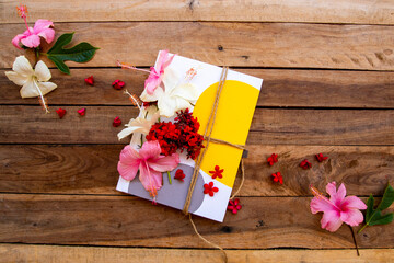 notebook planner for business work with flowers colorful hibiscus arrangement flat lay style on background wooden