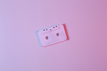 White audio cassette in pink-blue neon light. Minimalism music concept