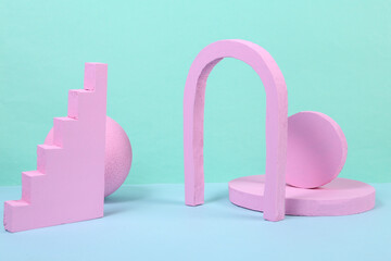 Different pink geometric shapes on blue background. Creative abstract layout