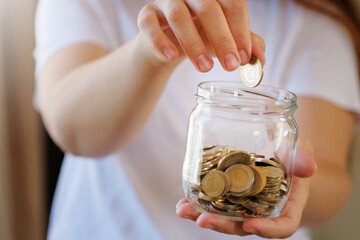 Turkish lira banknotes and coins in glass jar,woman hand. The paper currency of Turkey. Current...