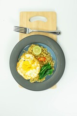 Indonesian Mie Goreng or Fried Noodle with egg traditional Indonesian or Chinese food with mustard greens