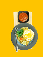 Indonesian Mie Goreng or Fried Noodle with egg traditional Indonesian or Chinese food with mustard greens