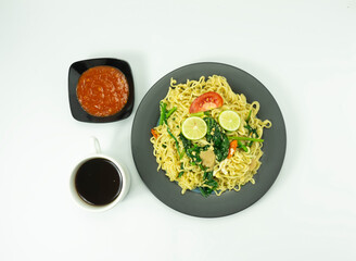 Indonesian Mie Goreng Nyemek or Fried Noodle with egg traditional Indonesian or Chinese food with mustard greens